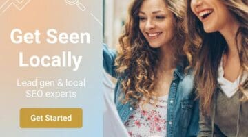 Two women smiling and looking at a tablet, promoting local SEO for clothing boutiques.