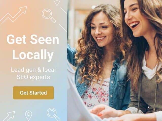 Two women smiling and looking at a tablet, promoting local SEO for clothing boutiques.